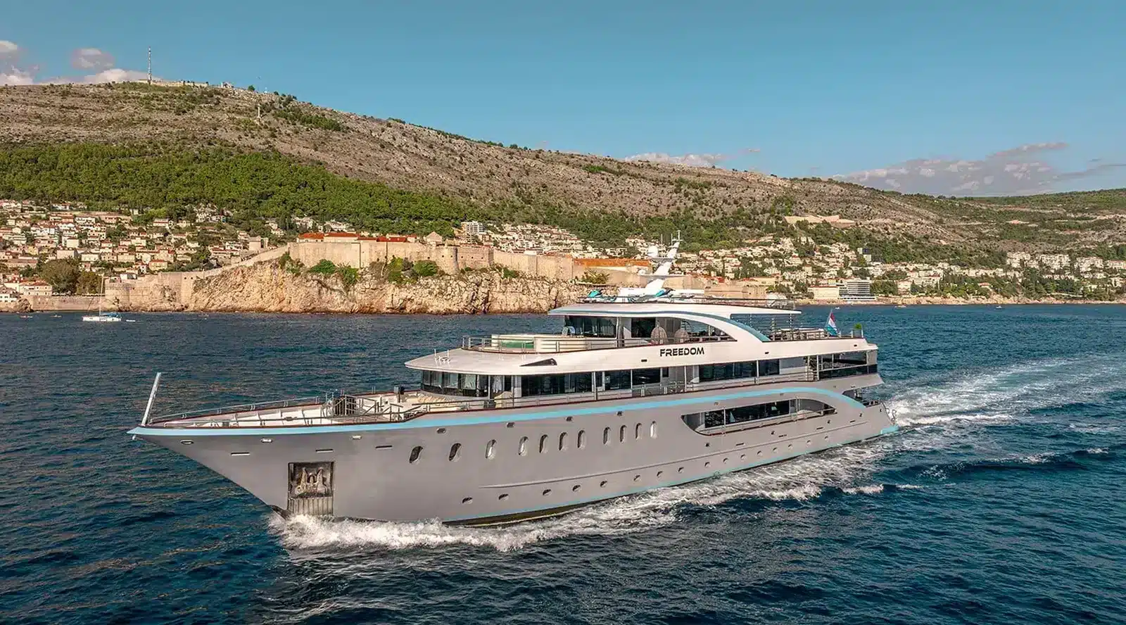 Luxury yacht charter Croatia Freedom Cruising Yacht Near Dubrovnik Caption: The sleek Freedom yacht glides over sparkling blue waters by a scenic coastal town. Description: The 1freedom_cruising.jpg features the luxury yacht Freedom charter sailing near Dubrovnik, Croatia—a perfect setting for high-end Mediterranean adventures. Cavtat Yachts Dubrovnik, yacht charter Croatia